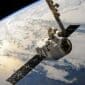 McCollisters A satellite or spacecraft, supported by an aerospace logistics partner, orbits above Earth with solar panels extended and the planet’s cloud-covered surface visible in the background.